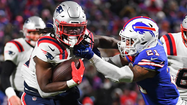 Buffalo Bills free safety Jordan Poyer (21) tackles New England Patriots running back Rhamondre Stevenson (38) on a run during the second half at Highmark Stadium.